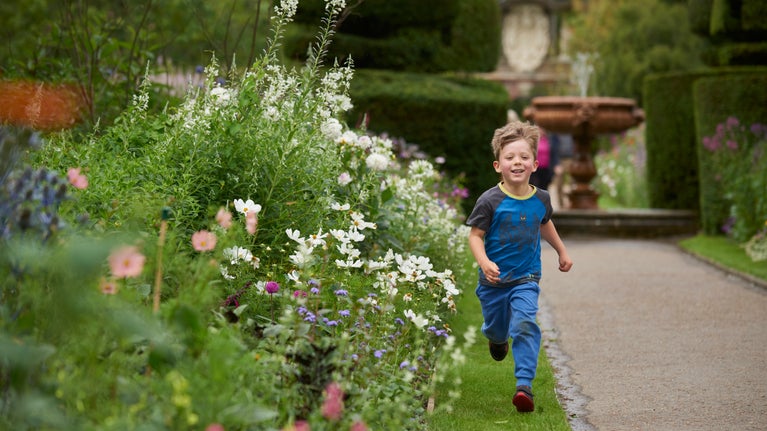 Child running through the Walled Garden at Nymans